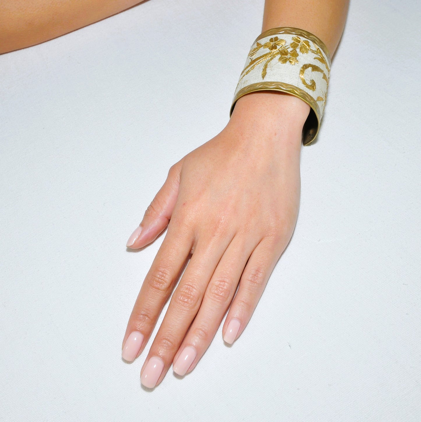 The Brass Cuff Bracelet on off-white Antique Embroidered cotton muslin